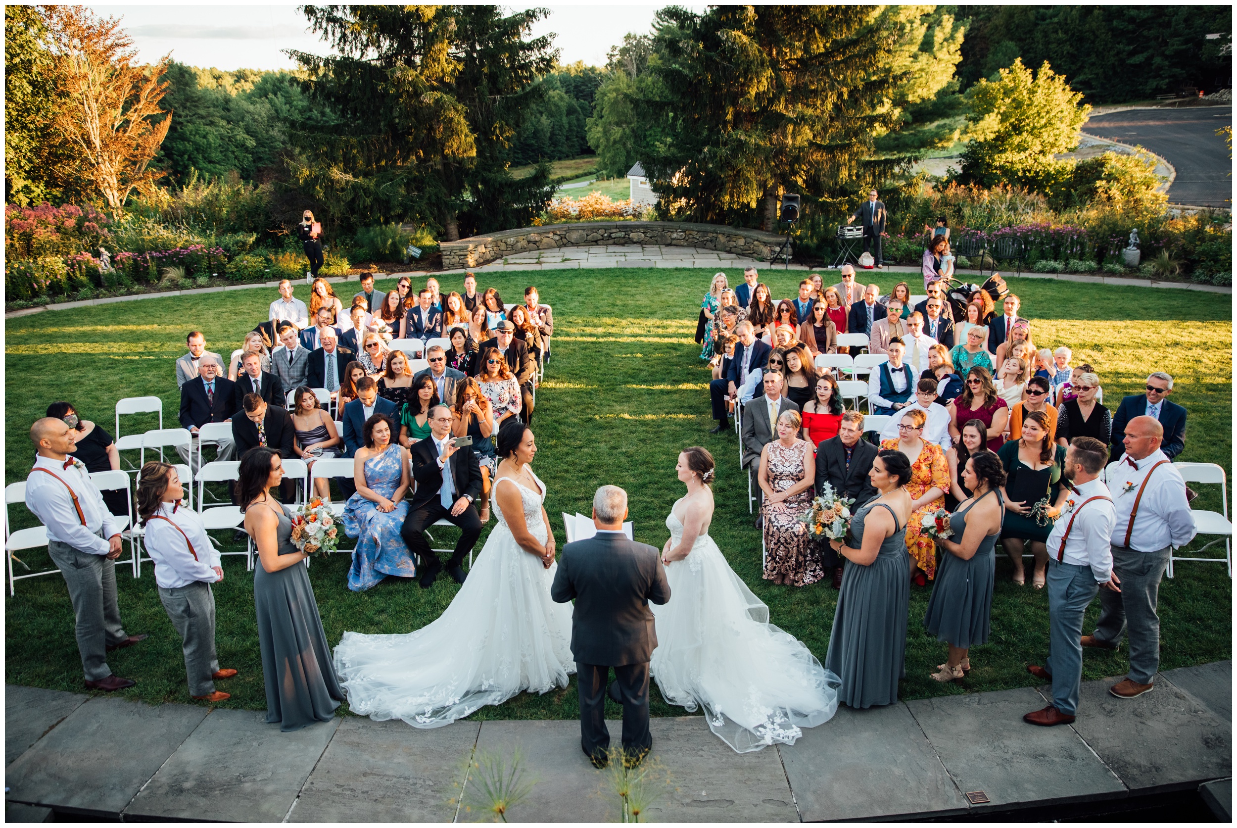 Two brides exchanging vows during outdoor ceremony at New England Botanic Garden at Tower Hill in Massachusetts